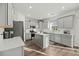 Modern kitchen featuring gray cabinets, quartz countertops, stainless steel appliances, and a center island at 1105 Mossy Rock Dr, Summerville, SC 29485