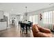 Modern kitchen with stainless steel appliances, white cabinets, eat-in island, and adjacent dining area at 1105 Mossy Rock Dr, Summerville, SC 29485
