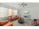 Inviting living room featuring a fireplace, large windows, ceiling fan, and comfortable seating at 1105 Mossy Rock Dr, Summerville, SC 29485