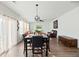 Open-concept dining and living area with a fireplace, hardwood floors, and lots of natural light at 1105 Mossy Rock Dr, Summerville, SC 29485
