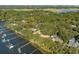 An aerial image captures waterfront homes with boat docks along a river, surrounded by lush greenery at 119 Riverland Dr, Charleston, SC 29412
