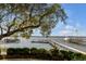 Scenic waterfront view featuring a wooden dock, a charming gazebo, and a boat under a blue sky at 119 Riverland Dr, Charleston, SC 29412