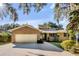 Charming single-story brick home featuring a two-car garage, well-maintained landscaping, and a welcoming front entrance at 119 Riverland Dr, Charleston, SC 29412