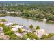 Aerial view of houses surrounding a pond with many trees at 121 Jakes Ln, Mount Pleasant, SC 29464