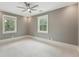 Neutral bedroom featuring two windows offering abundant natural light and a ceiling fan at 121 Jakes Ln, Mount Pleasant, SC 29464