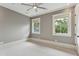 Bright bedroom with two windows showcasing outside greenery and a contemporary ceiling fan at 121 Jakes Ln, Mount Pleasant, SC 29464