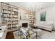 Elegant living room with fireplace, built-in bookshelves and stylish chandelier at 121 Jakes Ln, Mount Pleasant, SC 29464