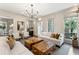 Elegant living room with a fireplace, two sofas, modern lighting, large windows, and stylish decor at 121 Jakes Ln, Mount Pleasant, SC 29464