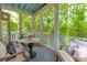 Inviting screened-in patio with comfortable seating, a ceiling fan, and lush greenery views at 121 Jakes Ln, Mount Pleasant, SC 29464