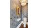 Stylish powder room with decorative wallpaper, modern fixtures, and elegant lighting at 121 Jakes Ln, Mount Pleasant, SC 29464