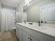 Bathroom featuring a double sink vanity, a large mirror and a shower/tub with white tile at 121 Warbler Way, Summerville, SC 29483