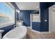 This main bath includes a standalone tub, large window, and granite countertops at 121 Warbler Way, Summerville, SC 29483