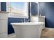 Close up of an elegant standalone tub with window view and beautiful vanity at 121 Warbler Way, Summerville, SC 29483
