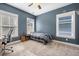 Bright bedroom features three large windows, blue walls, and a bed at 121 Warbler Way, Summerville, SC 29483