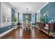Sunlit dining room featuring teal walls, hardwood floors, and a large window at 121 Warbler Way, Summerville, SC 29483
