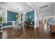 Stylish dining room with hardwood floors, a modern light fixture, and elegant decor in a bright space at 121 Warbler Way, Summerville, SC 29483