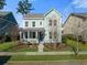 Beautiful two-story home with a charming front porch, landscaped yard, and a welcoming curb appeal at 121 Warbler Way, Summerville, SC 29483