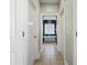 Hallway view leading to the main bath with white trim, neutral paint and tile floors at 121 Warbler Way, Summerville, SC 29483