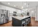 Well-equipped kitchen with stainless steel appliances, a granite island, and stylish pendant lighting at 121 Warbler Way, Summerville, SC 29483