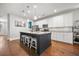 Modern kitchen with a large island, granite countertops, and white cabinets, ideal for cooking and gathering at 121 Warbler Way, Summerville, SC 29483