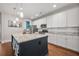 Bright kitchen featuring white cabinetry, a granite island with seating, and modern appliances for a seamless cooking experience at 121 Warbler Way, Summerville, SC 29483