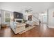 Bright living room with hardwood floors, a fireplace, and comfortable seating, perfect for relaxation and entertaining at 121 Warbler Way, Summerville, SC 29483