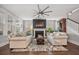 Living room with modern sofas, a fireplace, and a large ceiling fan at 121 Warbler Way, Summerville, SC 29483