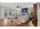 Bright living room with modern sofas, a ceiling fan, and a fireplace at 121 Warbler Way, Summerville, SC 29483