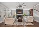 Cozy living room featuring a fireplace, comfortable seating, and natural light from large windows at 121 Warbler Way, Summerville, SC 29483