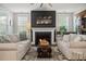 Cozy living room featuring a fireplace, comfortable sofas, and a stylish rug for a welcoming atmosphere at 121 Warbler Way, Summerville, SC 29483