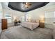 This large main bedroom has a unique tray ceiling, carpeted floors, and lots of natural light at 121 Warbler Way, Summerville, SC 29483