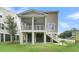Elevated home showcasing a screened in back porch and large backyard at 1308 Lieben Rd, Mount Pleasant, SC 29466