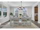 Bright dining room features a modern chandelier, and lots of natural light from the large windows at 1308 Lieben Rd, Mount Pleasant, SC 29466