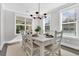 The Dining Room features a large window, modern chandelier, and seating for six at 1308 Lieben Rd, Mount Pleasant, SC 29466