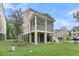 Side view of home featuring a screened in back porch and a well-manicured lawn at 1308 Lieben Rd, Mount Pleasant, SC 29466