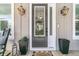Inviting home entrance with decorative lanterns, plants, and a charming welcome mat at 1308 Lieben Rd, Mount Pleasant, SC 29466