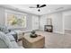 Spacious living area with a comfortable sectional sofa, woven ottoman, ceiling fan, and ample natural light at 1308 Lieben Rd, Mount Pleasant, SC 29466