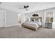 Comfortable main bedroom with a ceiling fan, cozy bed, neutral walls, and a view of the bathroom at 1308 Lieben Rd, Mount Pleasant, SC 29466