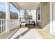 Inviting screened porch featuring a cozy seating area with woven furniture and a neutral outdoor rug at 1308 Lieben Rd, Mount Pleasant, SC 29466