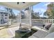 Relaxing screened-in porch with wicker furniture, comfortable cushions, and views of the surrounding neighborhood at 1308 Lieben Rd, Mount Pleasant, SC 29466