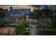 Stunning rear exterior showcasing a blue-grey home with a balcony and lush landscaping at 15 Watroo Pt, Daniel Island, SC 29492