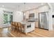 Chef's kitchen featuring custom cabinetry, marble countertops, and a stainless steel refrigerator at 15 Watroo Pt, Daniel Island, SC 29492