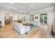 Bright, open living room featuring hardwood floors, coffered ceilings, and two sofas over a large rug at 15 Watroo Pt, Daniel Island, SC 29492