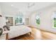 Bright main bedroom with built-in shelves, window seats, and light hardwood floors at 15 Watroo Pt, Daniel Island, SC 29492