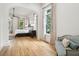 Spacious main bedroom with hardwood floors, large windows, and a seating area, creating a luxurious and inviting atmosphere at 15 Watroo Pt, Daniel Island, SC 29492