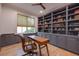 Stylish home office featuring custom built-in shelves, a wooden desk, and a comfortable chair, perfect for productivity at 15 Watroo Pt, Daniel Island, SC 29492
