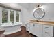 Elegant bathroom featuring a soaking tub, a window, and a vanity with stone countertops at 150 Royal Assembly Dr, Charleston, SC 29492