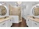 Bathroom features dual sinks, a glass shower, chandelier, and dark wood floors at 150 Royal Assembly Dr, Charleston, SC 29492