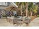 Cozy outdoor patio with comfortable seating, umbrella, and lush landscaping at 150 Royal Assembly Dr, Charleston, SC 29492