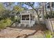 Backyard featuring outdoor seating, perfect for entertaining, with a screened porch above at 161 Marsh Hawk Ln, Kiawah Island, SC 29455